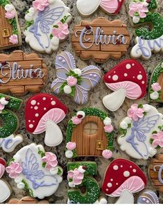 decorated cookies are arranged in the shape of fairy houses and mushrooms with name written on them