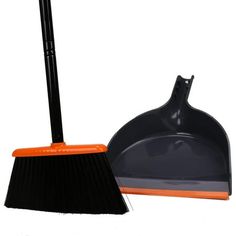 an orange and black dustpan and broom on a white background