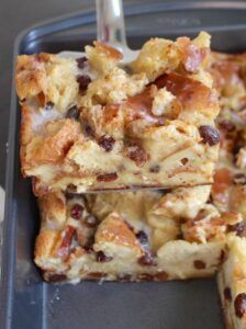 a close up of food on a pan with a fork in it and one slice missing