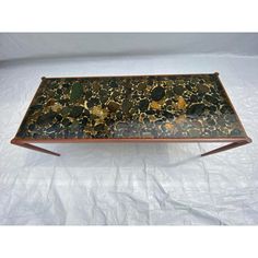 a black and gold tray with metal legs