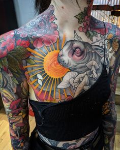 a woman with lots of tattoos on her chest