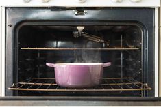 an oven with a pot in it and steam coming out