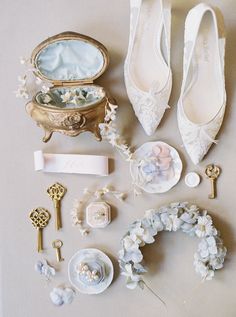 wedding accessories laid out on the floor next to each other, including shoes and jewelry