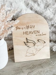 there is a wooden plaque with an image of a baby's name on it