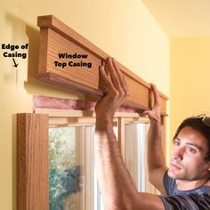 a man is working on a window with the top casing and bottom casing