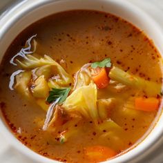 a white bowl filled with soup on top of a table