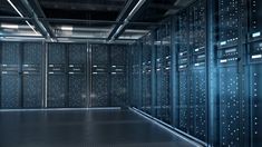 an empty server room with rows of servers in the back ground and lights shining on the floor