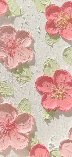 some pink flowers and green leaves on a white wall