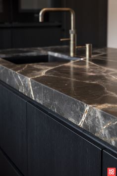 a marble counter top with a faucet and sink in the middle is shown