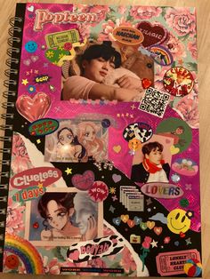 a spiral notebook covered in stickers and pictures