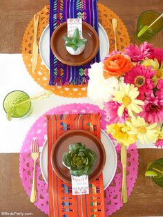 the table is set with colorful place settings