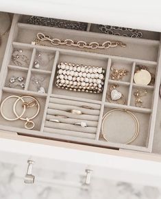 an open jewelry box filled with lots of rings and bracelets