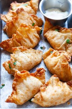 some fried food on a tray with dipping sauce