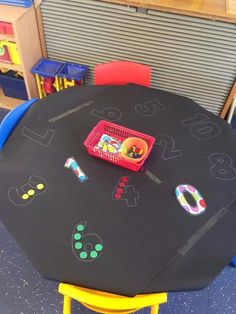 a black table topped with a basket filled with fruit and veggies on top of it