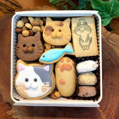 a box filled with lots of different types of cookies and treats on top of a wooden table