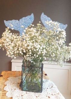 a vase filled with white flowers on top of a table