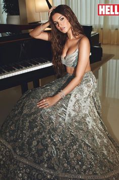 an image of a woman sitting in front of a piano with the words hello written on it