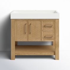 a white sink sitting under a wooden cabinet