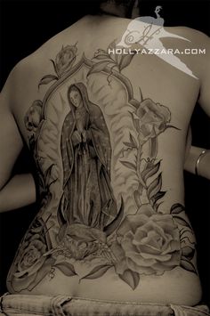 the back of a woman's body with tattoos on it and roses around her