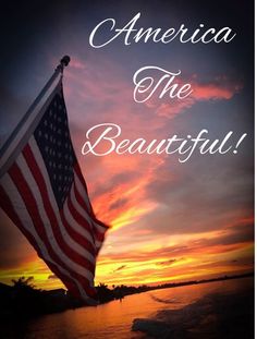 an american flag with the words america the beautiful in front of a sunset over water