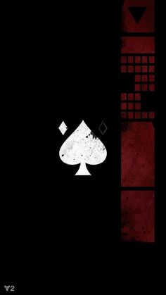 the back side of a black and red wallpaper with a playing card on it