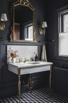 a white sink sitting under a large mirror next to a black and white checkered floor