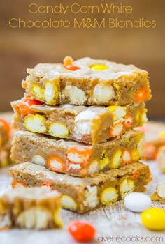 candy corn white chocolate m & m blondies are stacked on top of each other