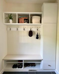 a white coat rack with shoes and other items