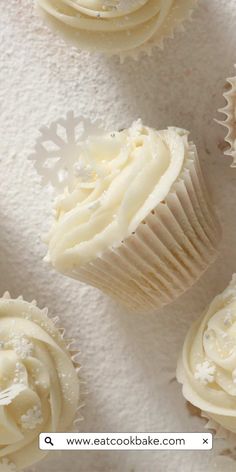 cupcakes with white frosting and snowflakes on top