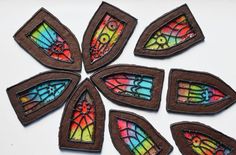 six pieces of stained glass are arranged in a circle