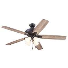 a ceiling fan with three wooden blades and two light bulbs on the top of it