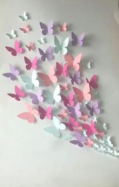 there are many butterflies on the wall in this room, and it looks like they have been made out of paper