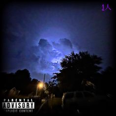 a dark sky with clouds and cars parked on the side of the road at night