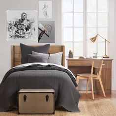 a bed room with a neatly made bed and pictures on the wall