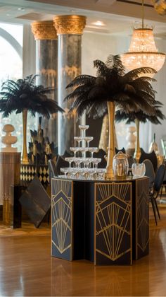 Art Deco themed event with a tiered glass centerpiece and palm leaf decorations.