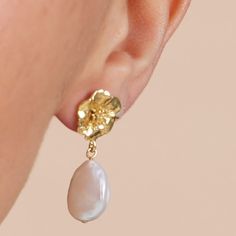 A statement pair of gold plated cherry blossom & baroque cultured freshwater pearl earrings which are bound to turn heads.    Full of character - these earrings are definite classic pearls with a modern twist.   ﻿ Gold plated sterling silver cherry blossom stud earrings with baroque cultured freshwater pearl drops.  Please note that no two pearls are the same and may vary slightly from the photo. Pearls are quite soft and need special care after you wear them. Always store them in a separate jewellery pouch away from other jewellery and it is best to keep them in something soft.  From time to time, after you wear your pearls you should wipe them with a soft damp cloth to prevent dirt, chemicals and perspiration from diminishing the lustre of the pearls.  Always remember to take off your Feminine Gold Petal Earrings, Feminine Gold Baroque Pearl Jewelry, Gold Delicate Baroque Pearl Earrings, Delicate Gold Baroque Pearl Earrings, Feminine Gold Petal Jewelry, Feminine Petal-shaped Gold Jewelry, Freshwater Pearl Drop Earrings, Jewellery Pouch, Freshwater Pearls Earrings