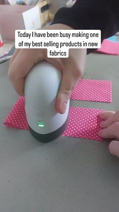 a person using a mouse on top of a table with pink polka dot tape around it