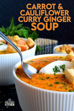 two bowls of roasted carrot and cauliflower curry glaze soup with bread croutons