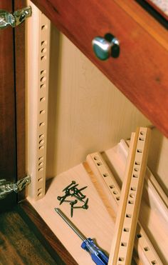 a pair of wooden drawers with writing on the bottom and one drawer opened to show an open drawer