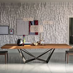 a dining room table with chairs and pictures on the wall