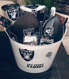 a bucket filled with footballs and other sports related items