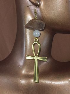 "These earrings are so fire and beautiful. This earrings are  handcrafted with white Quartz with touch a wooden beads. The Ankh means or key of life is an ancient Egyptian hieroglyphic symbol that was most commonly used in writing and in Egyptian art to represent the word for \"life\" and, by extension, as a symbol of life itself. The white Quartz is said to the  stone of master healing. The Egyptian is good combination with Ankh for fashion statement. These crystal are cleanse with salt water b Spiritual Ankh Jewelry For Jewelry Making, Brown Spiritual Dangle Jewelry, Handmade Ankh Spiritual Jewelry, Spiritual White Earrings For Gift, Spiritual Bronze Drop Earrings, White Spiritual Pierced Jewelry, Handmade Symbolic Ankh Earrings, Bronze Spiritual Earrings As Gift, Gold Nickel-free Spiritual Crystal Earrings