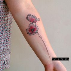 a woman's arm with a flower tattoo on it