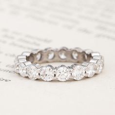 a diamond ring sitting on top of a piece of paper