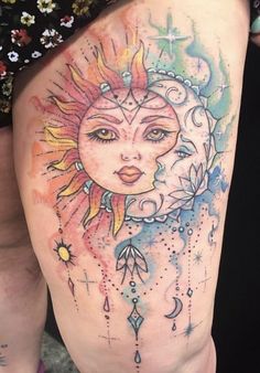 a woman's thigh with a sun and moon tattoo on it