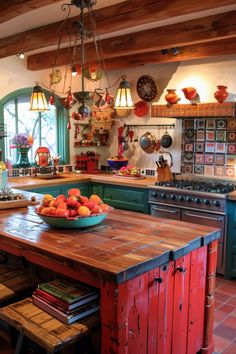 a bowl of fruit is sitting on the island in this rustic kitchen with green cabinets and red tile flooring