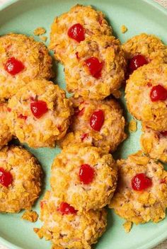 a plate full of cookies with cherries on them