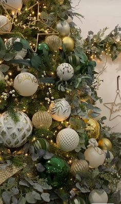 a christmas tree decorated with ornaments and greenery