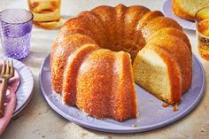 a bundt cake on a plate with one slice cut out and another half eaten