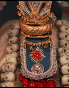 an elaborately decorated statue with skulls in the background